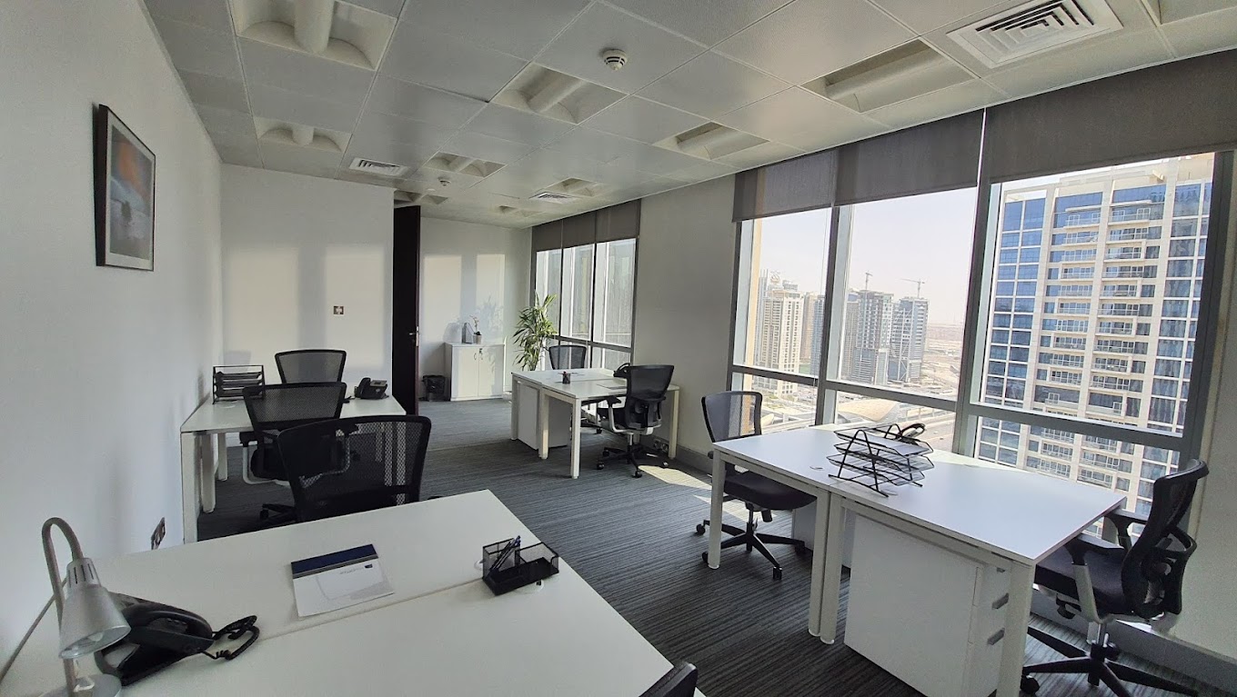 A myOffice business setup Dubai featuring a white corporate design inside Dubai Marina Plaza, with modern office furniture.