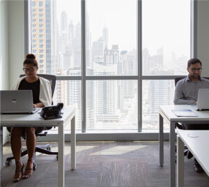 Two employees working beside each other at a private office in myOffice.