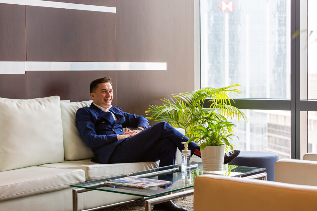 A professional corporate person relaxing in a modern lounge at myOffice.