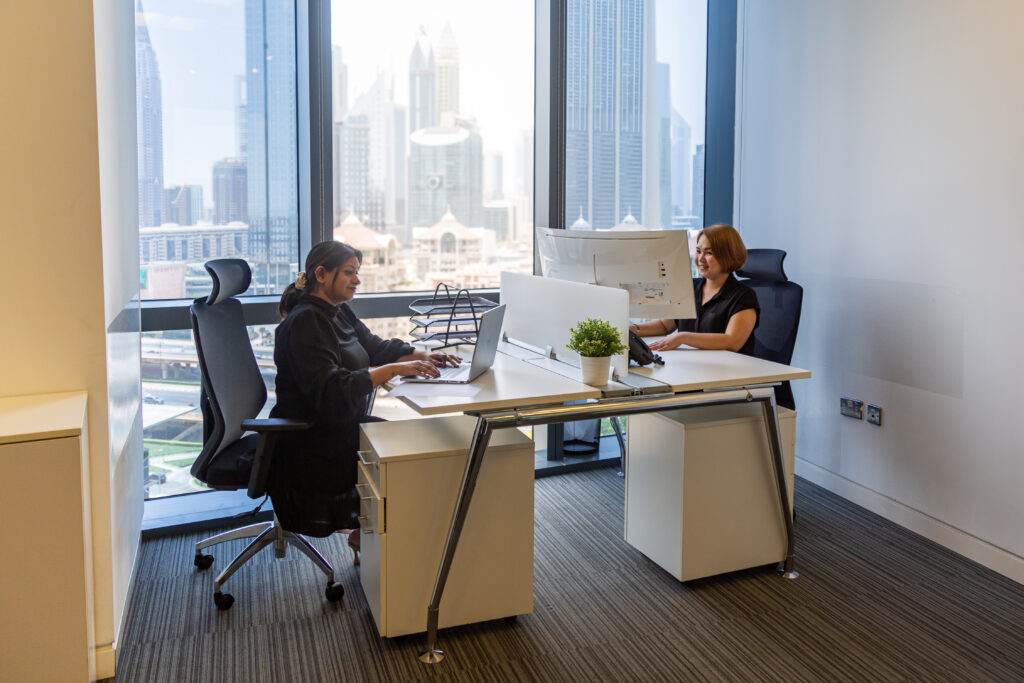 Two employees working in a private serviced office at myOffice Dubai.