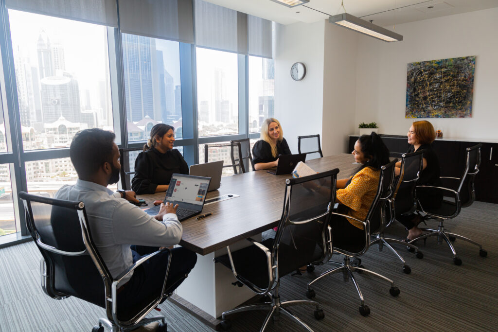 Professionals having a formal discussion in a meeting room at myOffice.