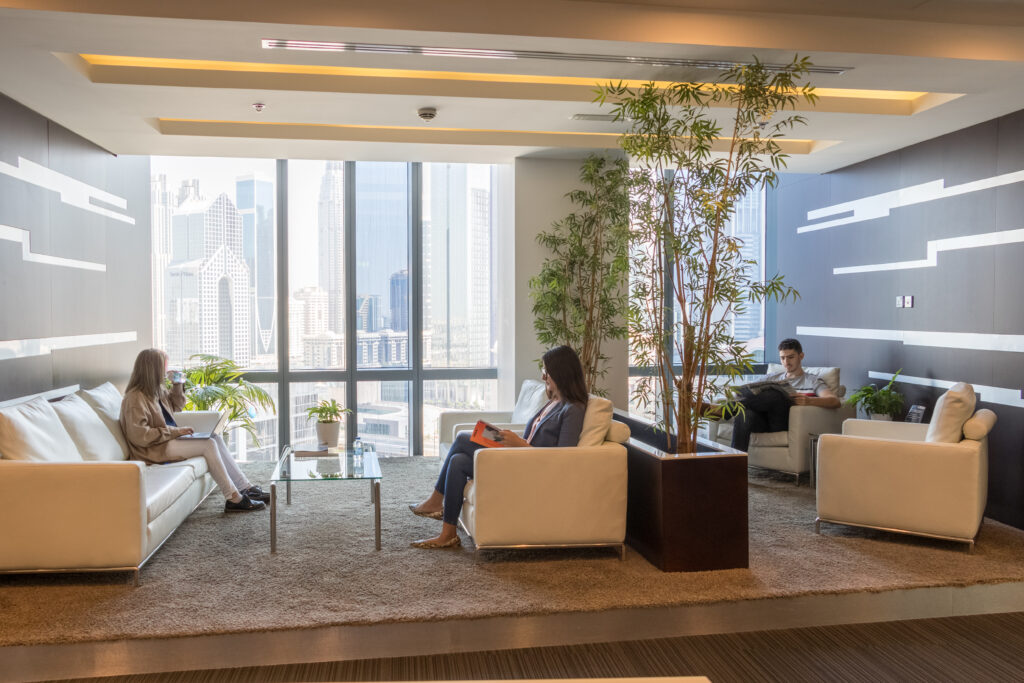 A modern lobby at myOffice with professionals working in their laptops